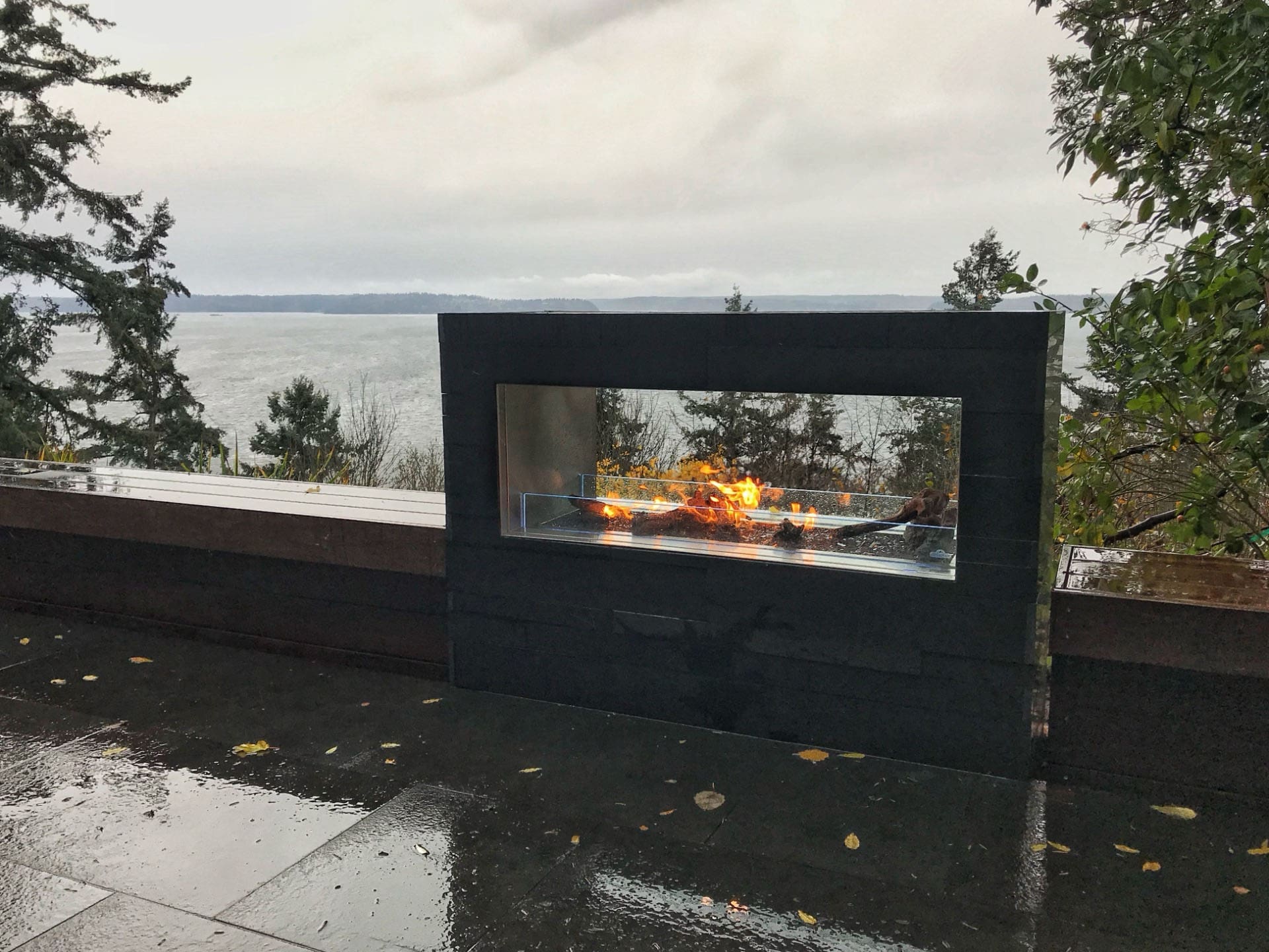 Rooftop outdoor fireplace overlooking the water.