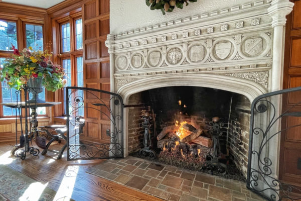 Large living room featuring an ornate fireplace with RH Peterson logs.