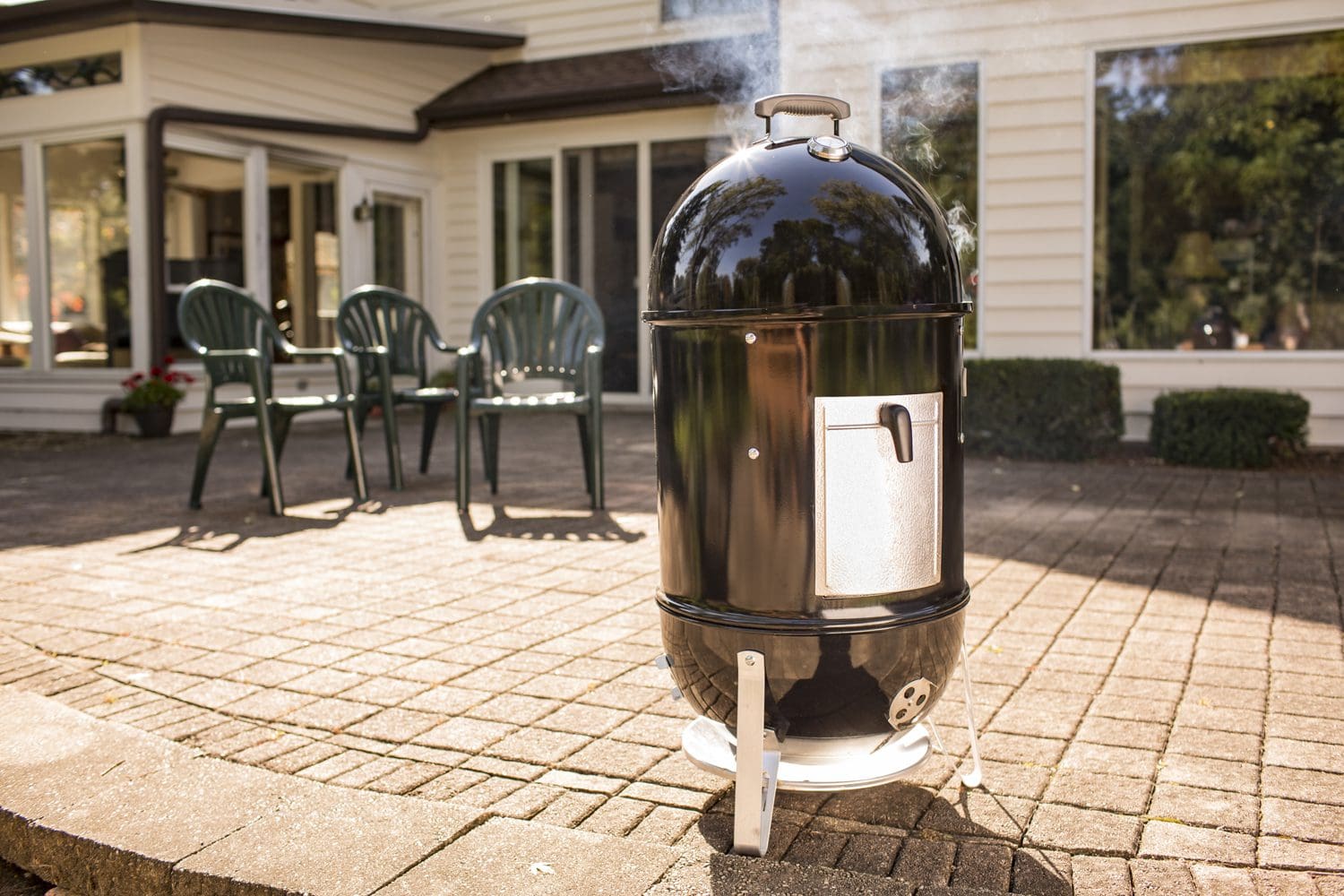 The Weber Smokey Mountain charcoal smoker on a patio