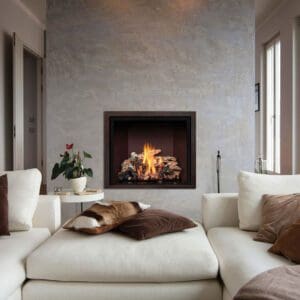 Modern yet traditional, the Mendota Fv41 gas fireplaces pairs perfectly in any space like it does in this neutral living room. The birch logs compliment the light colored furniture, and the aged leather trim accents the warm browns of the throw pillows