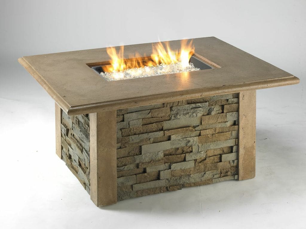 The Outdoor Greatroom Sierra Square Gas Fire Pit Table in tan with a rock base on a white background
