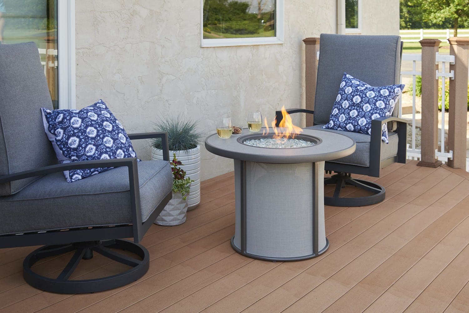 The outdoor greatroom stonefire fire pit table pictured on a porch