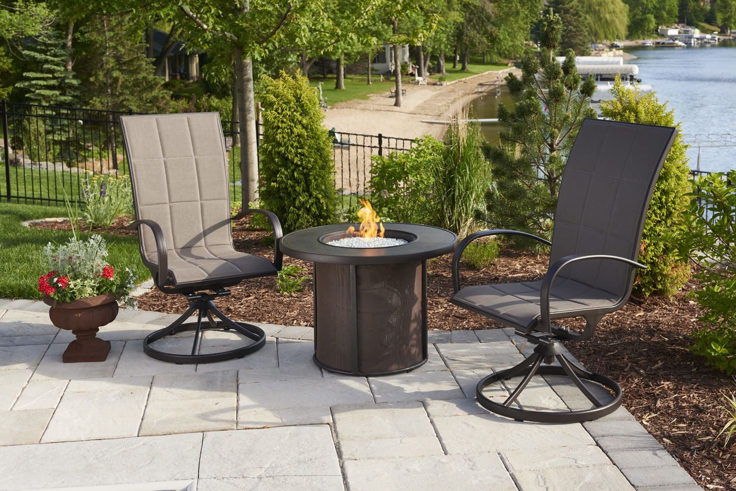 The outdoor greatroom stonefire fire pit table pictured in a lakeside home