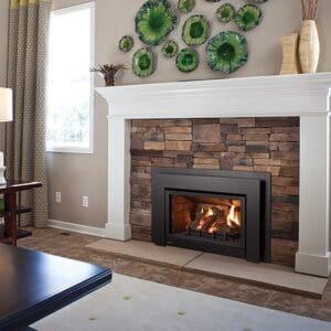 Picture of a Regency U31 gas insert set into a traditional brick fireplace with white mantel