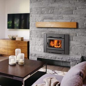 Regency Alterra CI1150 wood insert in a raised fireplace with gray irregular stone