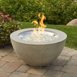 The Outdoor Greatroom Cove Round Gas Firepit Bowl is a contemporary take on concrete-finished firepits, with a natural gray finish to compliment any space.