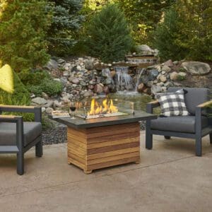 Picture of the Darien Gas Fire table by Outdoor Greatroom with matching chairs and glass wind guard