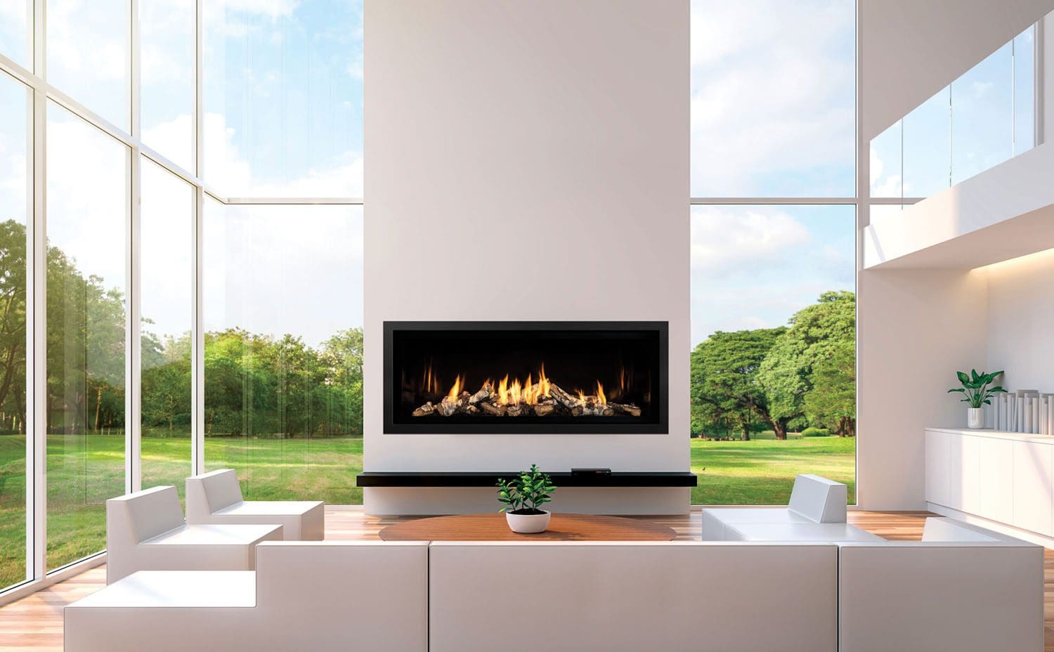 A modern living room with floor-to-ceiling windows, white minimalist furniture, wooden flooring, and a Mendota ML54 Linear gas fireplace as the focal point. A small potted plant is on the coffee table, with green trees visible outside.