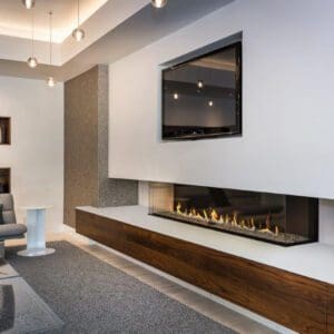 The Ortal three-sided gas fireplace offers stunning visuals. Choose between various media styles, optional reflective glass panels, and more.