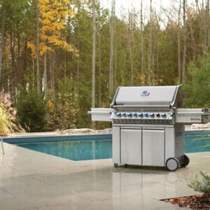 Picture of a Napoleon Prestige pro gas grill by a pool.