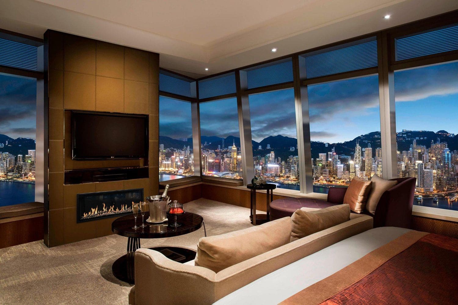 The Modern Flames Orion Slim Electric fireplace in a living room with a city skyline view