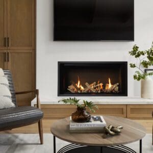 Valor LT1 linear gas fireplace set into a smooth drywall application with marble raised hearth and TV mounted above